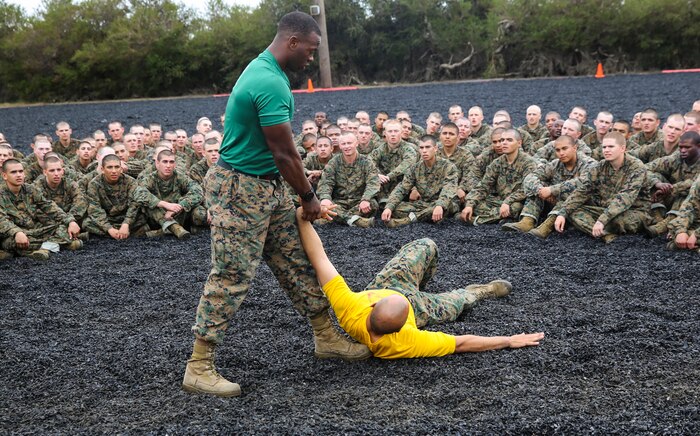 A Marine Corps Martial Arts Program instructor with the Instructional Training Company, Recruit Training Regiment, demonstrates a technique during a MCMAP session at Marine Corps Recruit Depot San Diego, Feb. 18. One of the purposes of MCMAP is to teach recruits basic offensive and defensive techniques, which gives them the opportunity to master the moves in preparation for the MCMAP test later in training. Annually, more than 17,000 males recruited from the Western Recruiting Region are trained at MCRD San Diego. Golf Company is scheduled to graduate April 29.