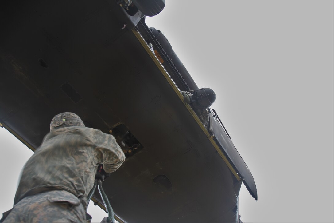 Army crew chiefs prepare to conduct slingload training with a UH-60 Black Hawk helicopter on Joint Base Lewis-McChord, Wash., Feb. 10, 2016. Army photo by Capt. Brian Harris