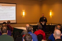 Maj. Christopher Buck, Recruiting Station Lansing, Mich., commanding officer, gives a class about leadership and teamwork to a room of Michigan high school football coaches during the 2016 Glazier Clinic in Grand Rapids, Mich., Feb. 20, 2016. The purpose of Marine Corps presence at the Glazier Clinics is to allow participating coaches the opportunity to learn more about how Marines can help their school's football team through physical and Warrior Ethos training and mentoring.