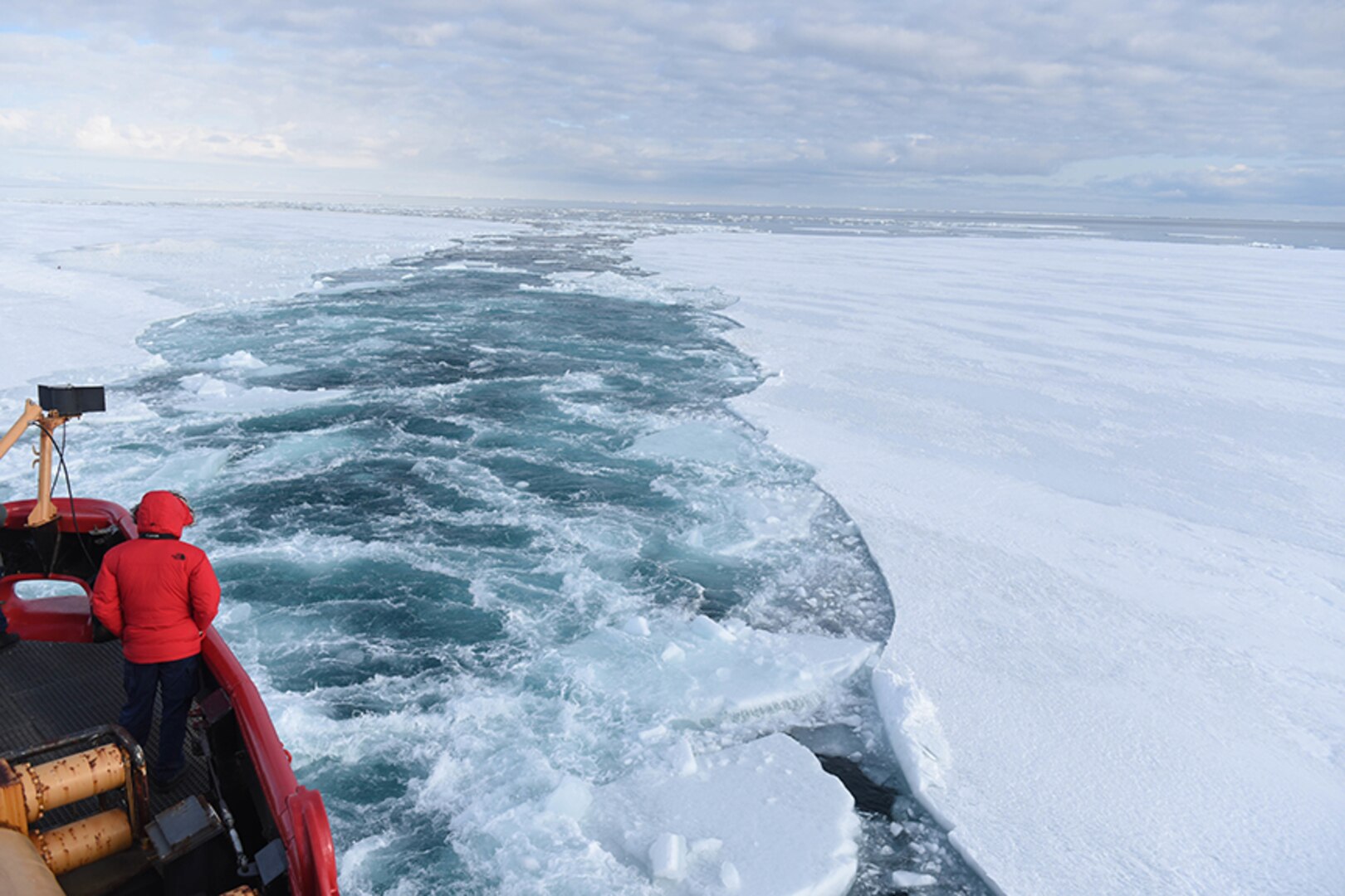 The Coast Guard Cutter Polar Star cuts a channel into a field of fast ice in McMurdo Sound, Antarctica, Jan. 7, 2016. During Operation Deep Freeze 2016, the U.S. military's logistical support to the National Science Foundation-managed U.S. Antarctic Program, the Polar Star's mission is to create a navigable channel to McMurdo Station for several resupply vessels.