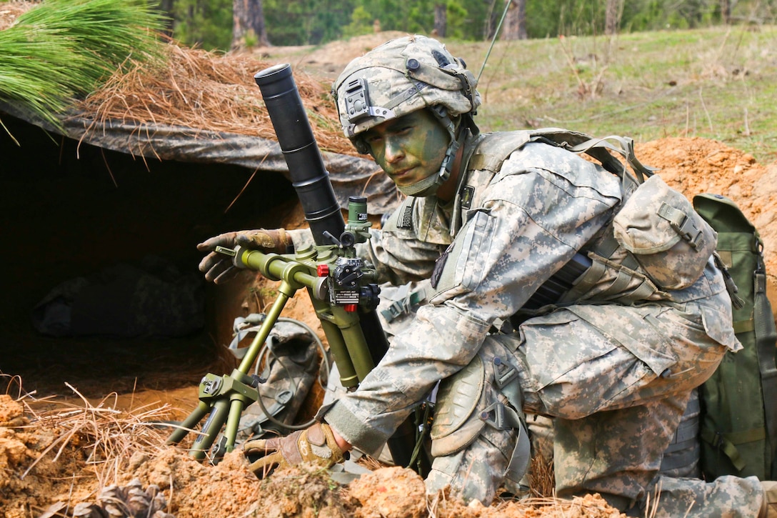 Army Staff Sgt. Adam Gomez adjusts his 60mm mortar system while improving a fighting position at Joint Readiness Training Center on Fort Polk, La., Feb. 20, 2016.  Army photo by Staff Sgt. Daniel Love