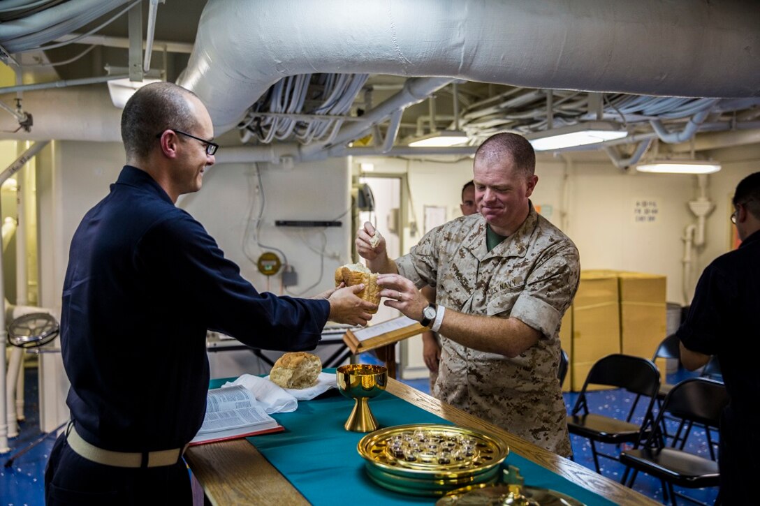 PACIFIC OCEAN (Feb. 14, 2016) – U.S. Navy Chaplains with the Boxer Amphibious Ready Group and 13th Marine Expeditionary Unit come together during a Holy Communion rite aboard the USS New Orleans, At Sea, Feb. 14, 2016. Religious services provide service members a break during the grueling schedule of deployment. More than 4,500 Marines and Sailors with the 13th Marine Expeditionary Unit and Boxer Amphibious Ready Group are transiting the Pacific Ocean en route to the Pacific and Central command areas of operations.