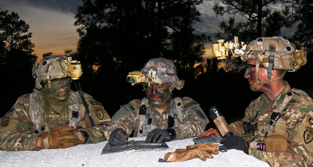 Leaders of Outlaw Platoon, C Company, 3rd Battalion, 509th Parachute Infantry Regiment, 4th Brigade, 25th Infantry Brigade Combat Team plan the defense of an urban center as night falls on Joint Readiness Training Center on Fort Polk, La., Feb. 20, 2016. The brigade has been training with U.K. and Canadian troops as well as role players assigned to the base to increase interoperability and test the deployability of various airborne unit sizes.  Army photo by Staff Sgt. Daniel Love