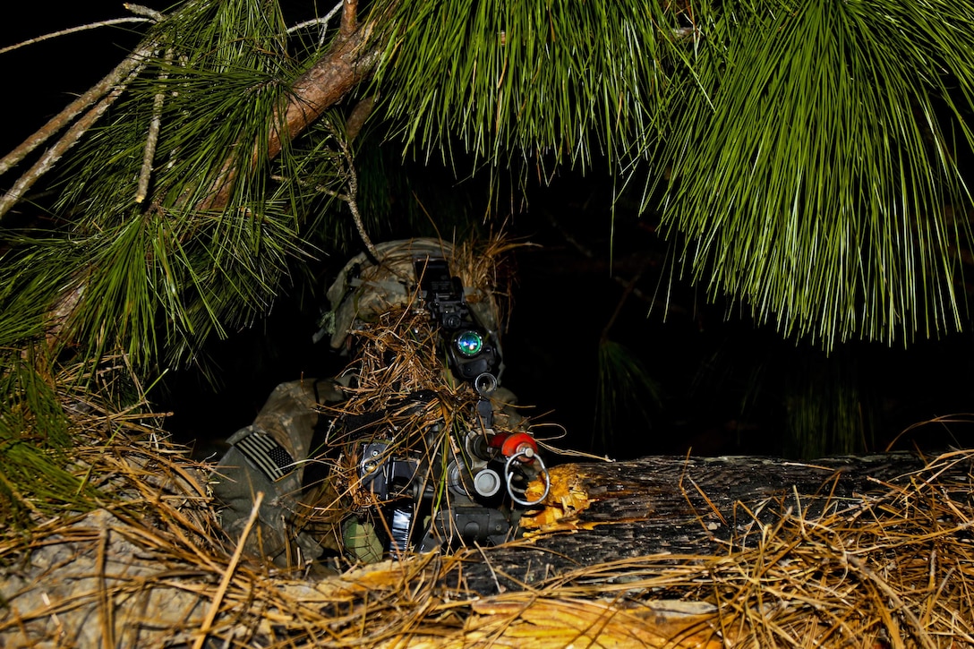 A paratrooper waits with his M249 SAW as night falls on Joint Readiness Training Center on Fort Polk, La., Feb. 20, 2016.  Army photo by Staff Sgt. Daniel Love