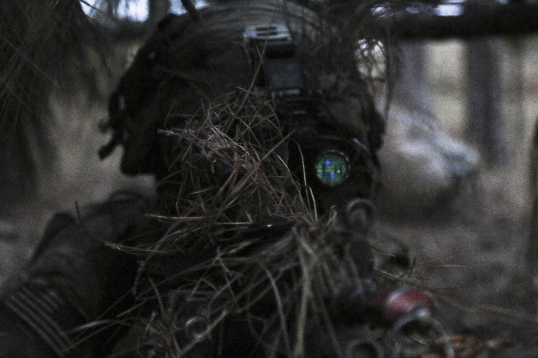 A paratrooper waits with his M249 SAW as night falls on Joint Readiness Training Center on Fort Polk, La., Feb. 20, 2016. Army photo by Staff Sgt. Daniel Love