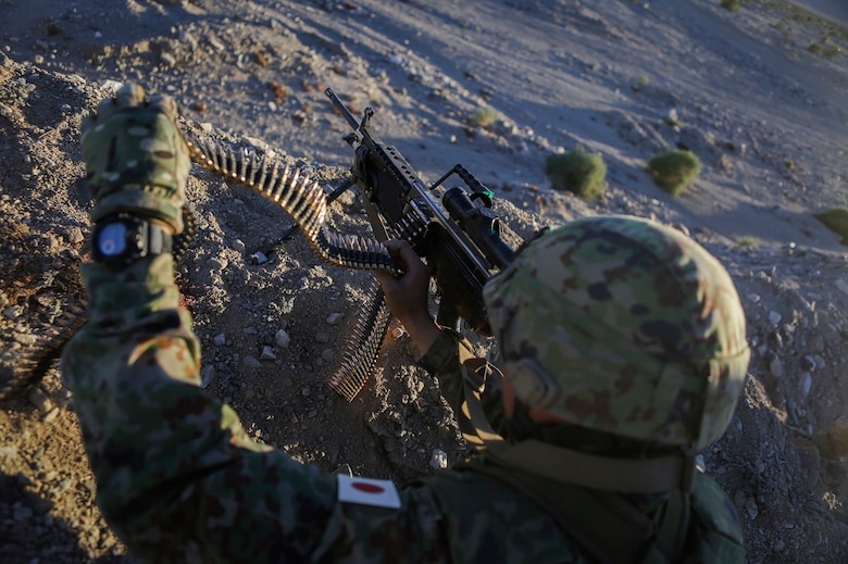 A machine gunner assigned to the Western Army Infantry Regiment, Japan Ground Self Defense Force, reloads a M249 squad automatic weapon during Exercise Iron Fist 2016, aboard Marine Corps Air Ground Combat Center Twentynine Palms, Calif., Feb. 9, 2016. Iron Fist is an annual, bi-lateral training exercise between the Japan Ground Self Defense Force and Marines to strengthen warfighting capabilities in ship to shore operations.