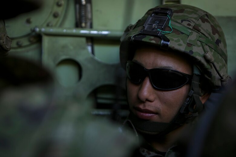 Sergeant Hatsumura Shoutarou, a rifleman with 3rd Company, Western Army Infantry Regiment, Japan Ground Self Defense Force, prepares to dismount an amphibious assault vehicle to conduct a live-fire platoon level assault during Exercise Iron Fist 2016, aboard Marine Corps Air Ground Combat Center Twentynine Palms, Feb. 9, 2016. Iron Fist is an annual, bi-lateral training exercise between the Japan Ground Self Defense Force and Marines to strengthen warfighting capabilities in ship to shore operations.