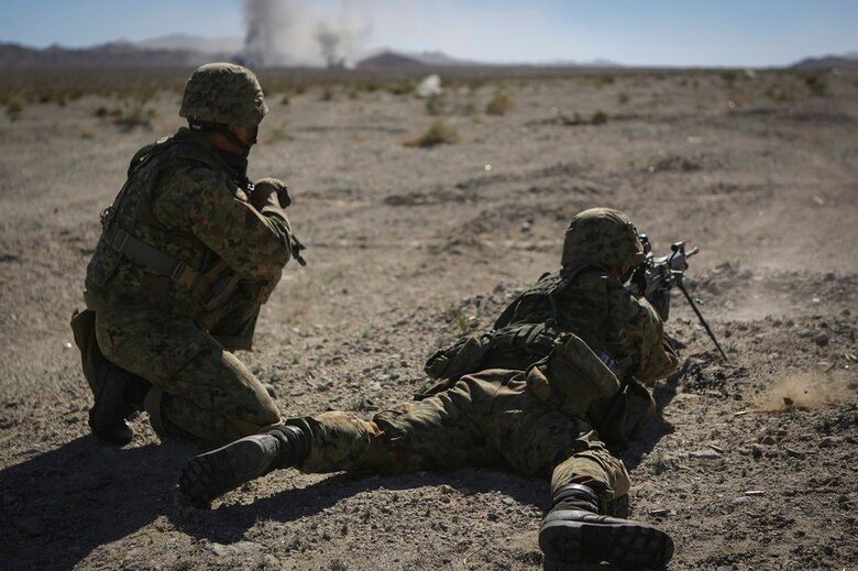 A machine gunner assigned to the Western Army Infantry Regiment, Japan Ground Self Defense Force, fires on simulated targets, during a live-fire platoon level assault during Exercise Iron Fist 2016 aboard Marine Corps Air Ground Combat Center Twentynine Palms, Feb 9, 2016. Iron Fist is an annual bilateral training exercise between the Japan Ground Self Defense Force and Marines to strengthen warfighting capabilities in ship to shore operations.