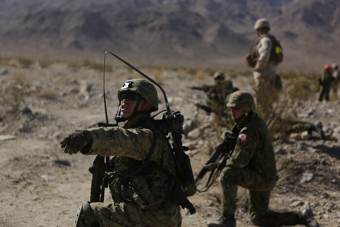 A field radio operator assigned to the Western Army Infantry Regiment, Japan Ground Self Defense Force, relays orders to his squad, during a live-fire platoon level assault during Exercise Iron Fist 2016 aboard Marine Corps Air Ground Combat Center Twentynine Palms, Feb. 9, 2016. Iron Fist is an annual, bi-lateral training exercise between the Japan Ground Self Defense Force and Marines to strengthen warfighting capabilities in ship to shore operations.
