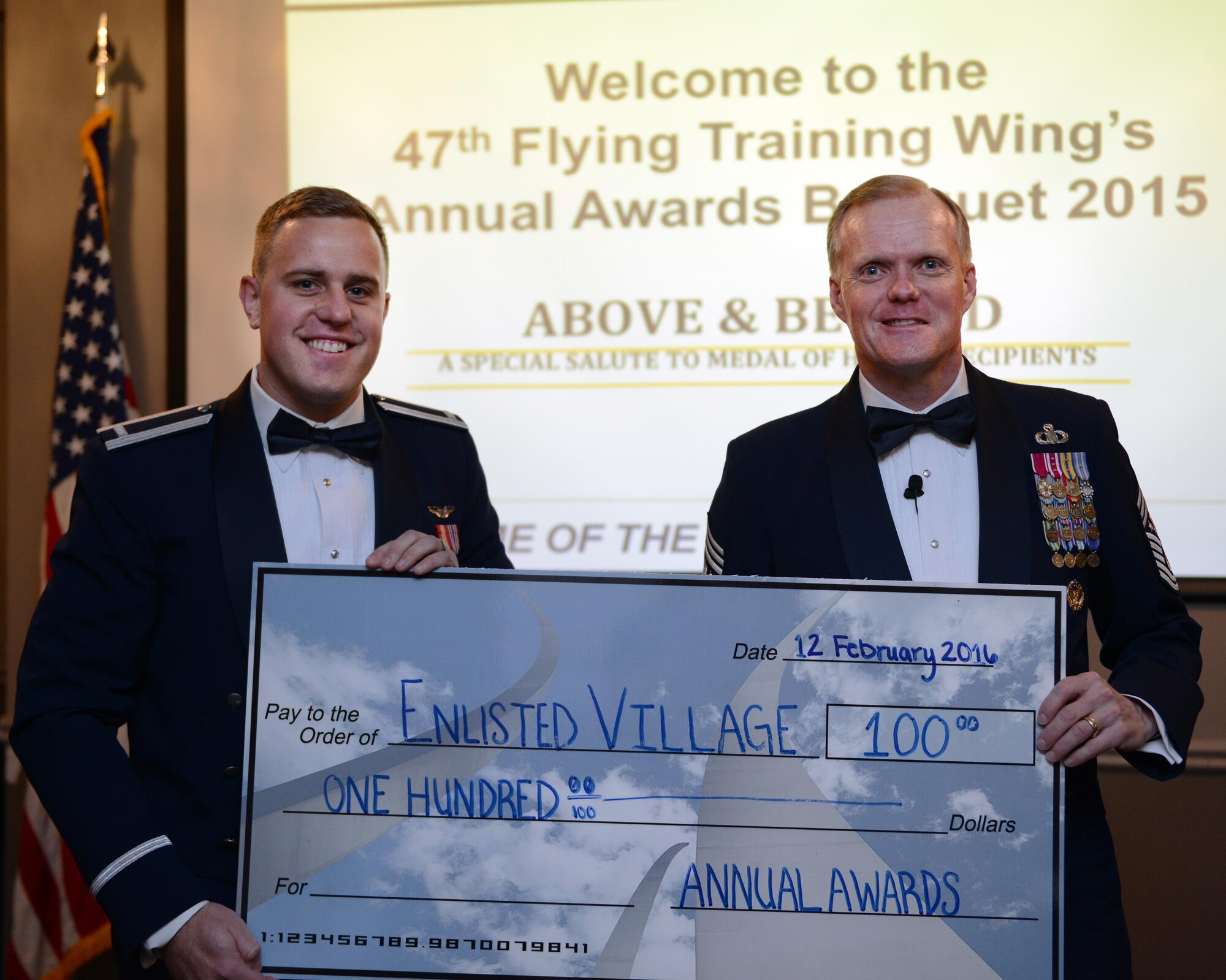 Chief Master Sgt. of the Air Force James Cody poses for a photo with 1st Lt. Matthew Elliot, 47th Student Squadron executive officer, at Laughlin Air Force Base, Texas, Feb. 12, 2016. Laughlin’s Annual Awards Banquet Committee donated $100 to the Enlisted Village on Cody’s behalf. (U.S. Air Force photo by Senior Airman Jimmie D. Pike) 