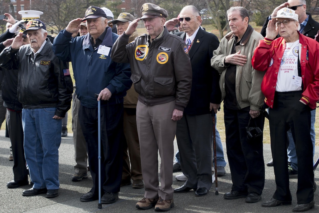 World War II veterans George Cattelona, Ira Rigger, Jerry Yellin, Gene Bell, Bud Hampton and John Lazere render honors during a wreath-laying ceremony at the Marine Corps War Memorial in Arlington, Va., Feb. 19, 2016. Several events in the Washington, D.C. area marked the 71st anniversary of the Battle for Iwo Jima. Marine Corps photo by Cpl. Chi Nguyen