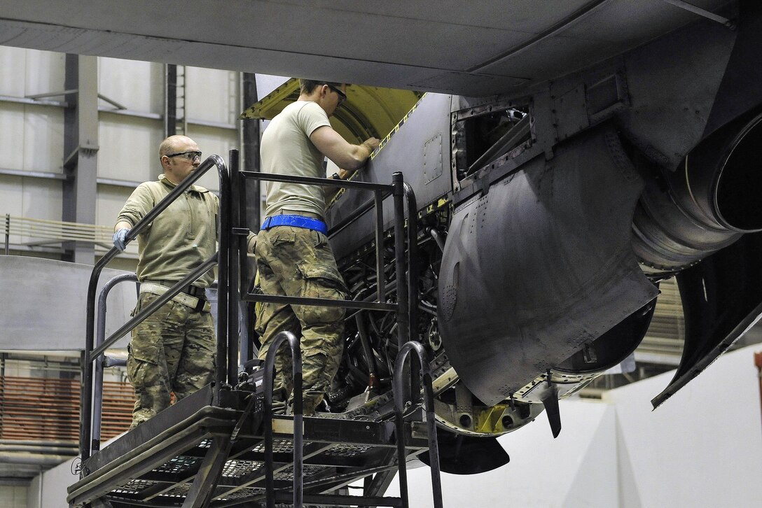 Air Force Staff Sgt. Matthew Templin, left, and Air Force Senior Airman Lee Harrell fix an EC-130 Compass Call engine on Bagram Airfield, Afghanistan, Feb. 10, 2016. Templin is an aerospace propulsion craftsman and Harrell is an instrument flight control systems journeyman assigned to the 455th Expeditionary Aircraft Maintenance Squadron. The EC-130 is a tactical weapon system that uses a heavily-modified version of the C-130 Hercules airframe and provides offensive systems that are capable of disrupting enemy command and control. Air Force photo by Tech. Sgt. Nicholas Rau
