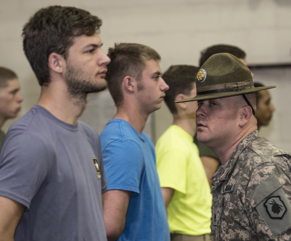 Army Reserve Drill Sergeant, Staff Sgt. Michael Merritt, 1st Battalion, 518th Infantry Regiment, 98th Training Division (IET), takes a peak to see if anyone is talking in formation during Future Soldier Day at the Reserve Center in Asheville, N.C., Feb. 20, 2016. The event was hosted by 1st Battalion, 518th Infantry Regiment and gives future Soldiers in the Army and Army Reserve an introduction to basic Warrior Tasks but more importantly gives the Reserve drill sgts. of the unit a chance to brush up on their skills as they gear up for their annual training mission in the basic combat training companies. (U.S. Army photo by Sgt. 1st Class Brian Hamilton)