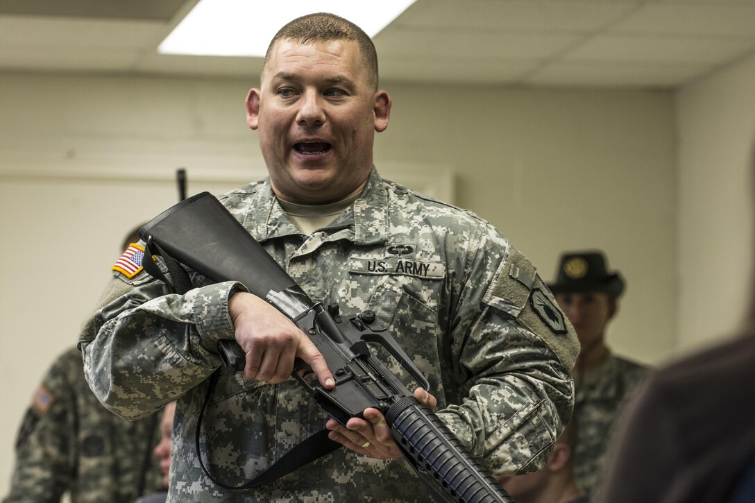 First Sgt. Anthony Childs, 1st Battalion, 518th Infantry Regiment, 98th Training Division (IET), gives a class on weapons safety to future Soldiers in the Army and Army Reserve at the Reserve Center in Asheville, N.C., Feb. 20, 2016. Childs helped coordinate the Future Soldiers program in which nearly 40 civillians from the area who have already or intend on enlisting into the Army showed up to recieve an introduction to basic Warrior tasks before they get to basic combat training. (U.S. Army photo by Sgt. 1st Class Brian Hamilton)