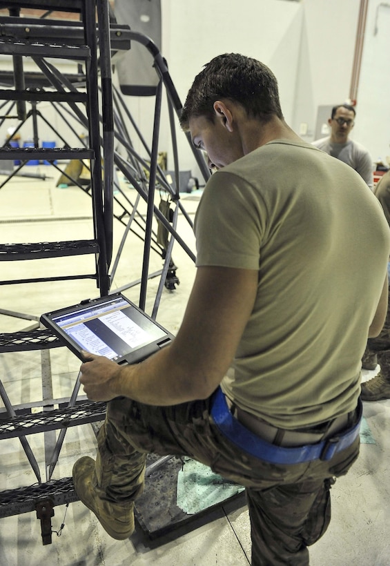 Air Force Senior Airman Lee Harrell reviews technical orders during a fix of an EC-130 Compass Call engine on Bagram Airfield, Afghanistan, Feb. 10, 2016. Harrell is an instrument flight control systems journeyman assigned to the 455th Expeditionary Aircraft Maintenance Squadron. Air Force photo by Tech. Sgt. Nicholas Rau