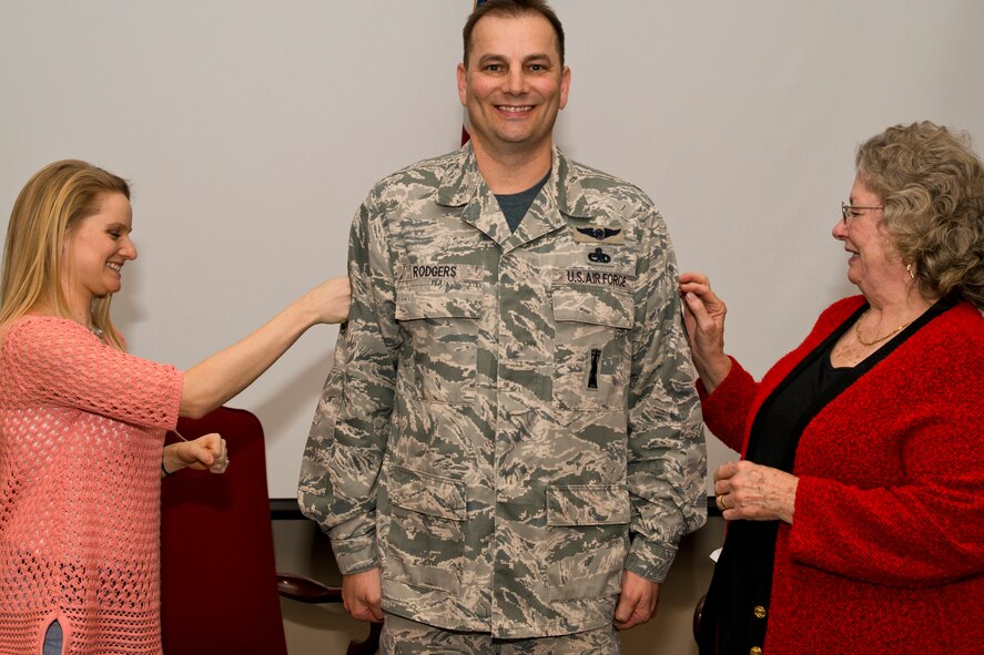 U.S. Air Force Reserve Chief Master Sgt. Scotty D. Rodgers, deputy superintendent, 913th Maintenance Squadron, gets his new rank pinned on by his wife Tiffany and mother Shirley during a promotion ceremony at Little Rock Air Force Base, Ark., Feb. 21, 2016. Rodgers, who hails from Rogers, Ark., joined the Air Force in July 1989. Lt. Col. Paul Centinaro, commander of the 913 MXS, was the presiding official for Rodgers’ promotion ceremony. (U.S. Air Force photo by Master Sgt. Jeff Walston/Released)   