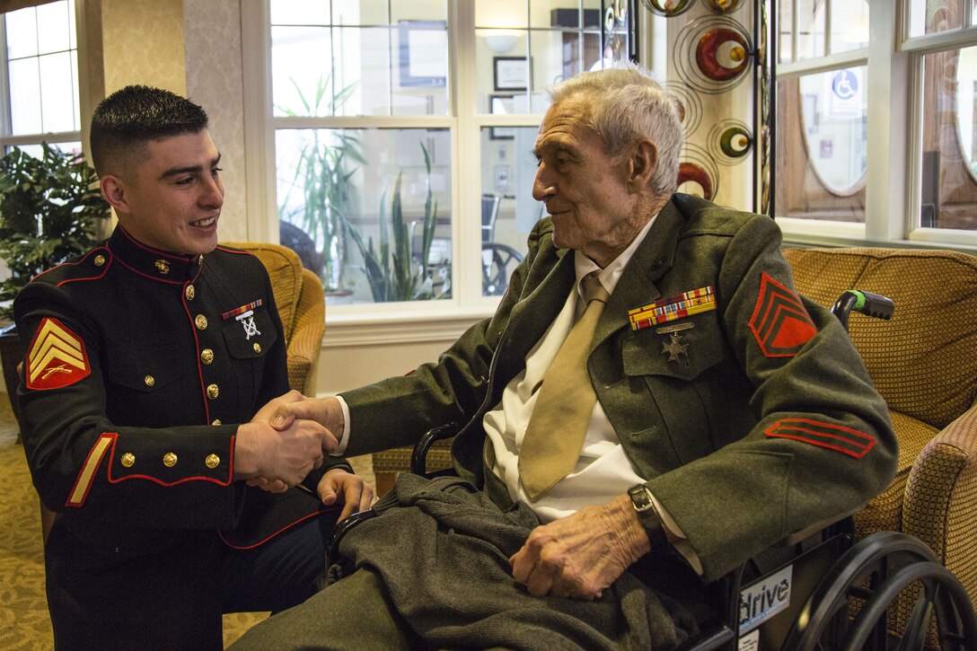 Sgt. Luis Urquijo, an administration/personnel specialist with Recruiting Station Denver, shakes hands with Ken Bradford, a World War II Marine
veteran, at the Sunrise at Orchard Senior Living Home in Littleton, CO, Feb.
21, 2016. Bradford served on Iwo Jima, Hawaii and Guam during his enlisted
career.   
