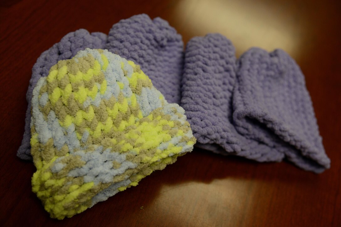 Knit hats rest on a table on Laughlin Air Force Base, Texas, Jan. 21, 2016. Senior Airmen Chey Weaver and Rebekah Sparks, both members of the 47th Medical Support Squadron, started the Heartstrings program with the hopes of giving back to the community while teaching a useful skill to fellow comrades. During their Heartstrings “lunch-n-loom” sessions, Weaver and Sparks teach attendees to crochet knit baby hats and donate the hand-made knit hats to the Val Verde Regional Medical Center, a local hospital, and local clinics for newborn babies. (U.S. Air Force photo by Senior Airman Ariel D. Partlow)