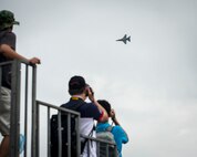 Spectators take pictures as a U.S. Air Force F-16C Fighting Falcon from the 35th Fighter Wing, Misawa Air Base, Japan, performs an aerial demonstration during the Singapore International Airshow, at Changi International Airport, Singapore, Feb. 20, 2016. The show was an opportunity for the U.S. to demonstrate flexible combat capabilities and to deter adversaries, while reassuring allies and partners. (U.S. Air Force photo by Capt. Raymond Geoffroy/Released)