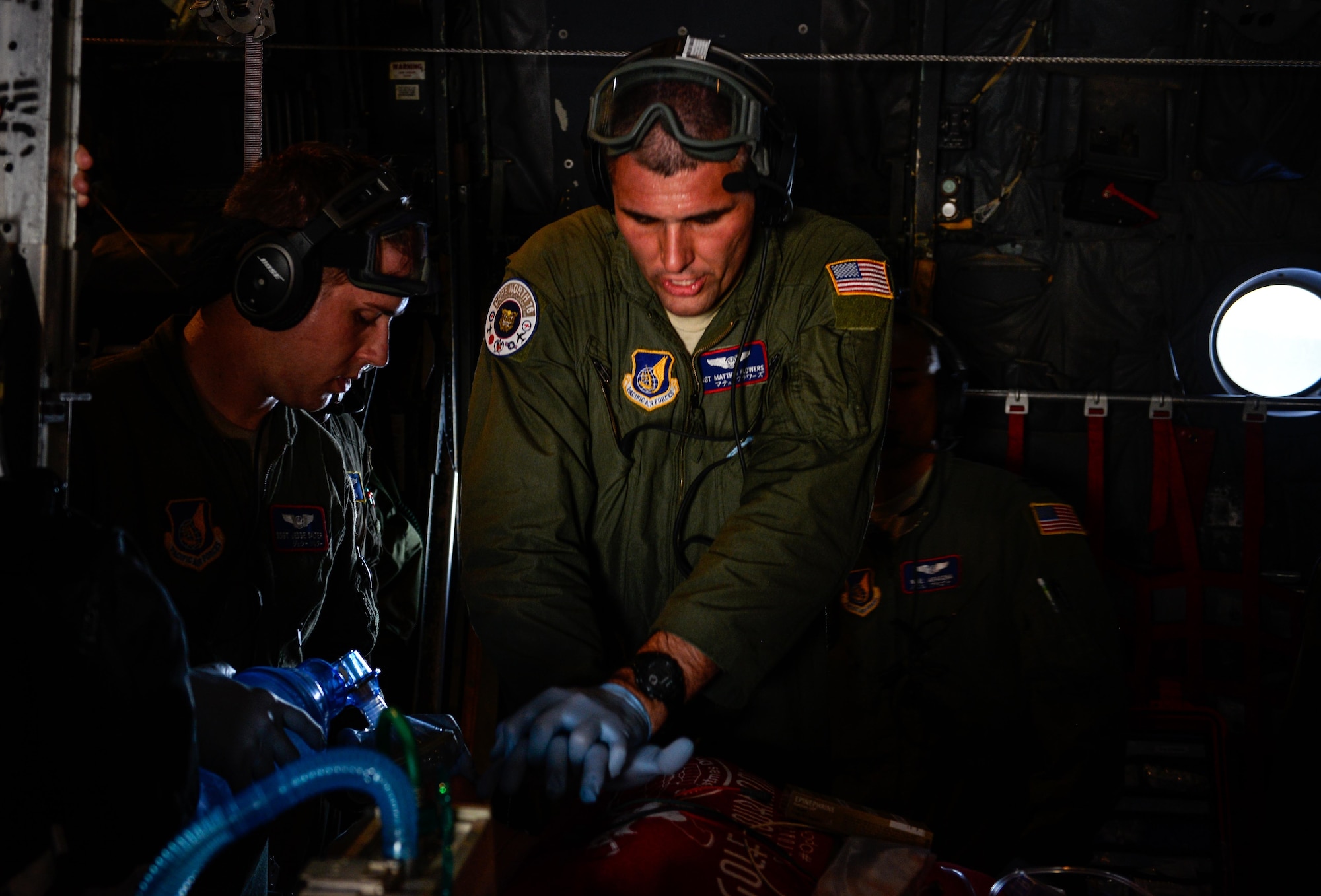 Staff Sgt. Matthew Flowers, an aeromedical evacuation technician with the 18th Aeromedical Evacuation Squadron, performs simulated CPR aboard a U.S. Air Force C-130 Hercules Feb. 15, 2016, during an expeditionary medical support exercise over the Pacific Ocean near Guam. Exercise Cope North 16 enhances humanitarian assistance and disaster relief crisis response capabilities between six nations and lays the foundation for regional cooperation during real-world contingencies in the Indo-Asia-Pacific region. (U.S. Air Force photo by Staff Sgt. Alexander W. Riedel/Released)