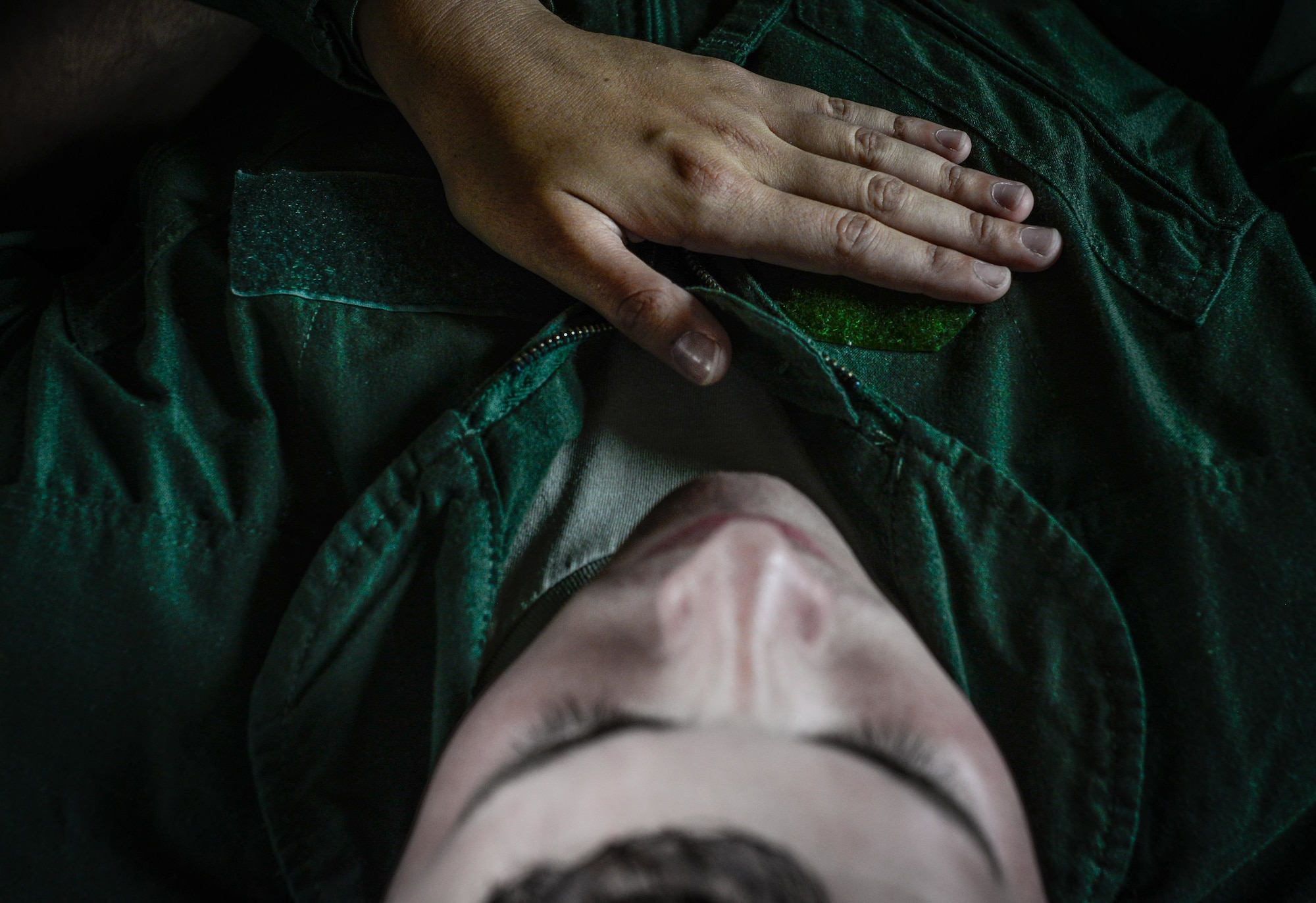 Royal New Zealand Air Force Leading Aircraftwoman Katherine Ruwhiu, a flight medic, comforts a patient with simulated injuries during a medical transfer training Feb. 17, 2016, at Andersen Air Force Base, Guam. Exercise Cope North 16 enhances humanitarian assistance and disaster relief crisis response capabilities between six nations and lays the foundation for regional cooperation expansion during real-world contingencies in the Indo-Asia-Pacific Region. (U.S. Air Force photo by Staff Sgt. Alexander W. Riedel/Released)