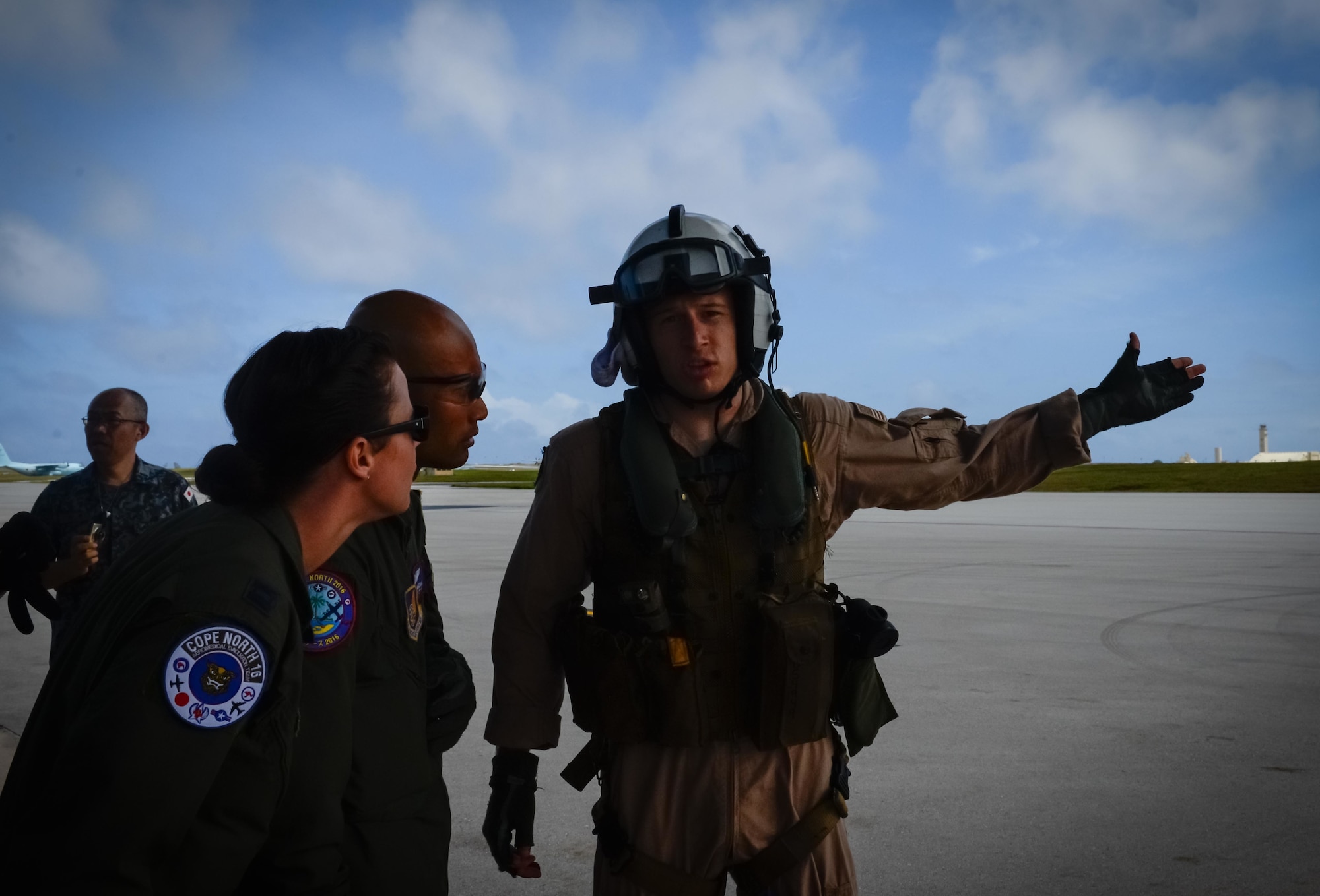 U.S. Navy Hospital Corpsman Brandon M. Smith, a search and rescue medical technician with Helicopter Sea Combat Squadron 25, right, gives patient information to a U.S. Air Force aeromedical evacuation crew during a patient transfer Feb. 17, 2016, at Andersen Air Force Base, Guam. Exercise Cope North 16 enhances humanitarian assistance and disaster relief crisis response capabilities between six nations and lays the foundation for regional cooperation expansion during real-world contingencies in the Indo-Asia-Pacific Region. (U.S. Air Force photo by Staff Sgt. Alexander W. Riedel/Released)