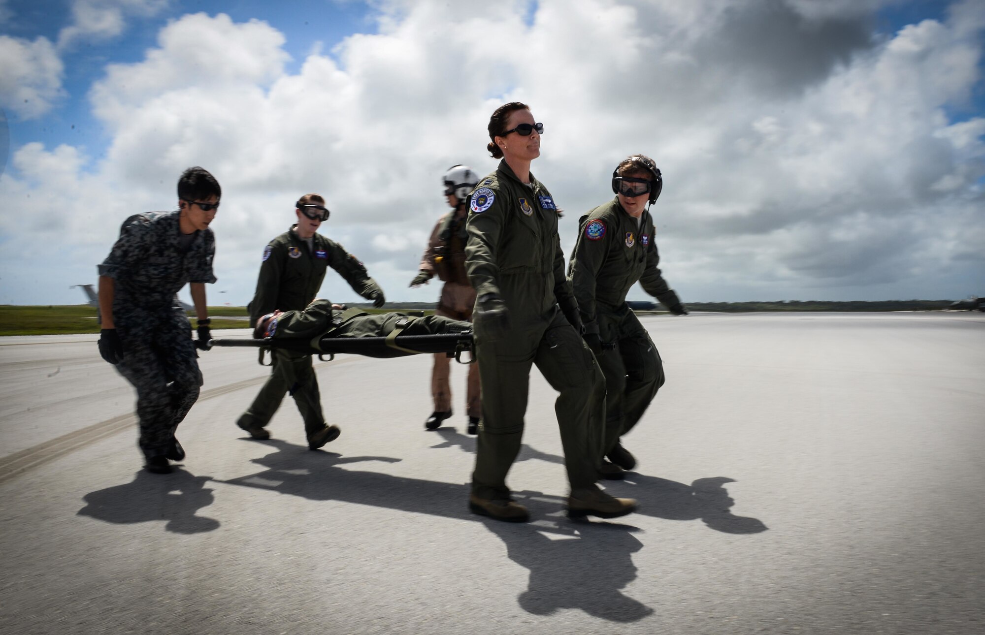 An aeromedical evacuation team of the Japan Air Self-Defense Force and U.S. Air Force carries a patient with simulated injuries from a  U.S. Navy MH-60S Seahawk to a waiting C-130 Hercules during a patient transfer training Feb. 17, 2016, at Andersen Air Force Base, Guam. Exercise Cope North 16 enhances humanitarian assistance and disaster relief crisis response capabilities between six nations and lays the foundation for regional cooperation expansion during real-world contingencies in the Indo-Asia-Pacific Region. The MH-60S is assigned to Helicopter Sea Combat Squadron 25. (U.S. Air Force photo by Staff Sgt. Alexander W. Riedel/Released)