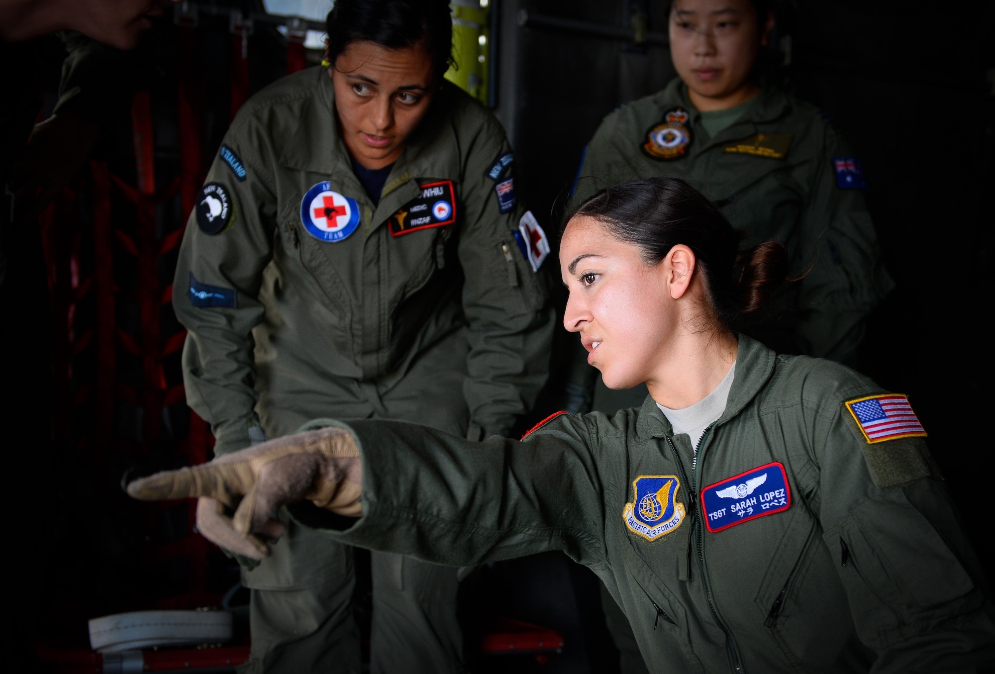 U.S. Air Force Tech. Sgt. Sarah Lopez, an aeromedical evacuation technician with the 18th Aeromedical Evacuation Squadron, front, works with New Zealand and Australian airmen during a medical transfer training Feb. 17, 2016, at Andersen Air Force Base, Guam. Exercise Cope North 16 enhances humanitarian assistance and disaster relief crisis response capabilities between six nations and lays the foundation for regional cooperation expansion during real-world contingencies in the Indo-Asia-Pacific Region. (U.S. Air Force photo by Staff Sgt. Alexander W. Riedel/Released)