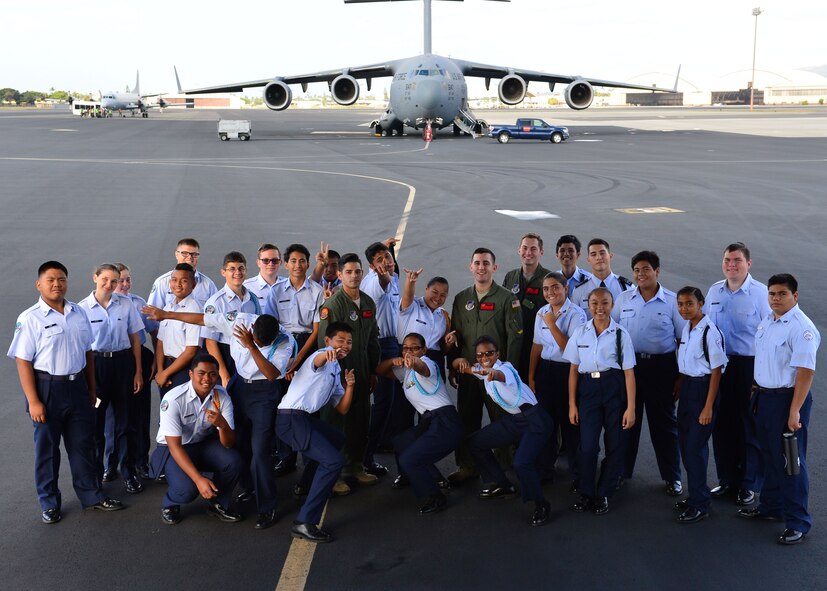 Students from Aiea High School’s Air Force Junior Reserve Officer Training Corps pose for a group photo on Joint Base Pearl Harbor-Hickam, Hawaii, Feb 18, 2016. The 30 JROTC students toured a C-17 Globemaster III and visited the 647th Explosive Ordnance Disposal unit and the 647th Security Forces Squadron's military working dog kennel during their visit to JBPHH. (U.S. Air Force photo by Tech. Sgt. Aaron Oelrich/Released) 