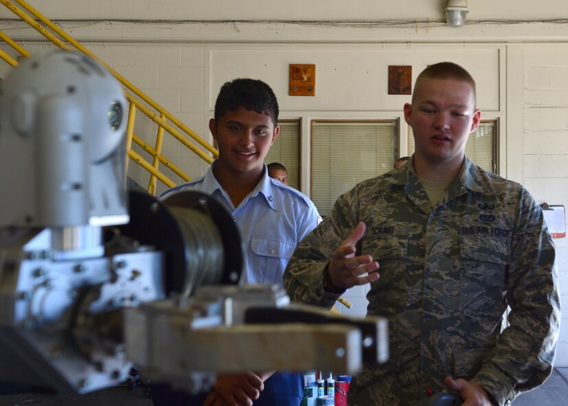 Cadet Senior Airman Elitah Lopez, from Aiea High School’s Air Force Junior Reserve Officer Training Corps, listens as Airman 1st Class Craig Austin, from 647th Explosive Ordnance Disposal, talks about the Air Force medium size robot on Joint Base Pearl Harbor-Hickam, Hawaii, Feb 18, 2016. The 30 JROTC students toured a C-17 Globemaster III and visited the 647th Explosive Ordnance Disposal unit and the 647th Security Forces Squadron's military working dog kennel during their visit to JBPHH. (U.S. Air Force photo by Tech. Sgt. Aaron Oelrich/Released) 