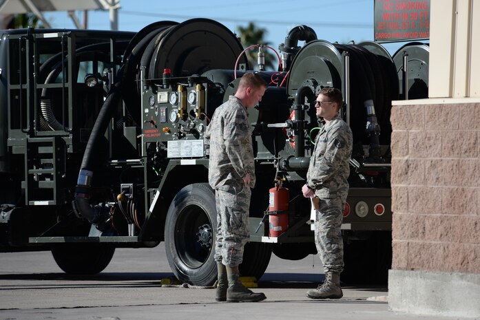 Staff Sgt. Spencer Hardesty (right), 99th Logistics Readiness Squadron firetruck/refueling truck mechanic, goes over the maintenance schedule for the R-12 refueling truck with Senior Airman Christopher Clanton, 99th LRS firetruck/refueling truck mechanic, at Nellis Air Force Base, Nev., Feb. 16. In the 2016 fiscal year, the maintenance unit is already responsible for 22 million gallons of fuel pumped, supporting 11,000 sorties.  (U.S. Air Force photo by Airman 1st Class Kevin Tanenbaum)