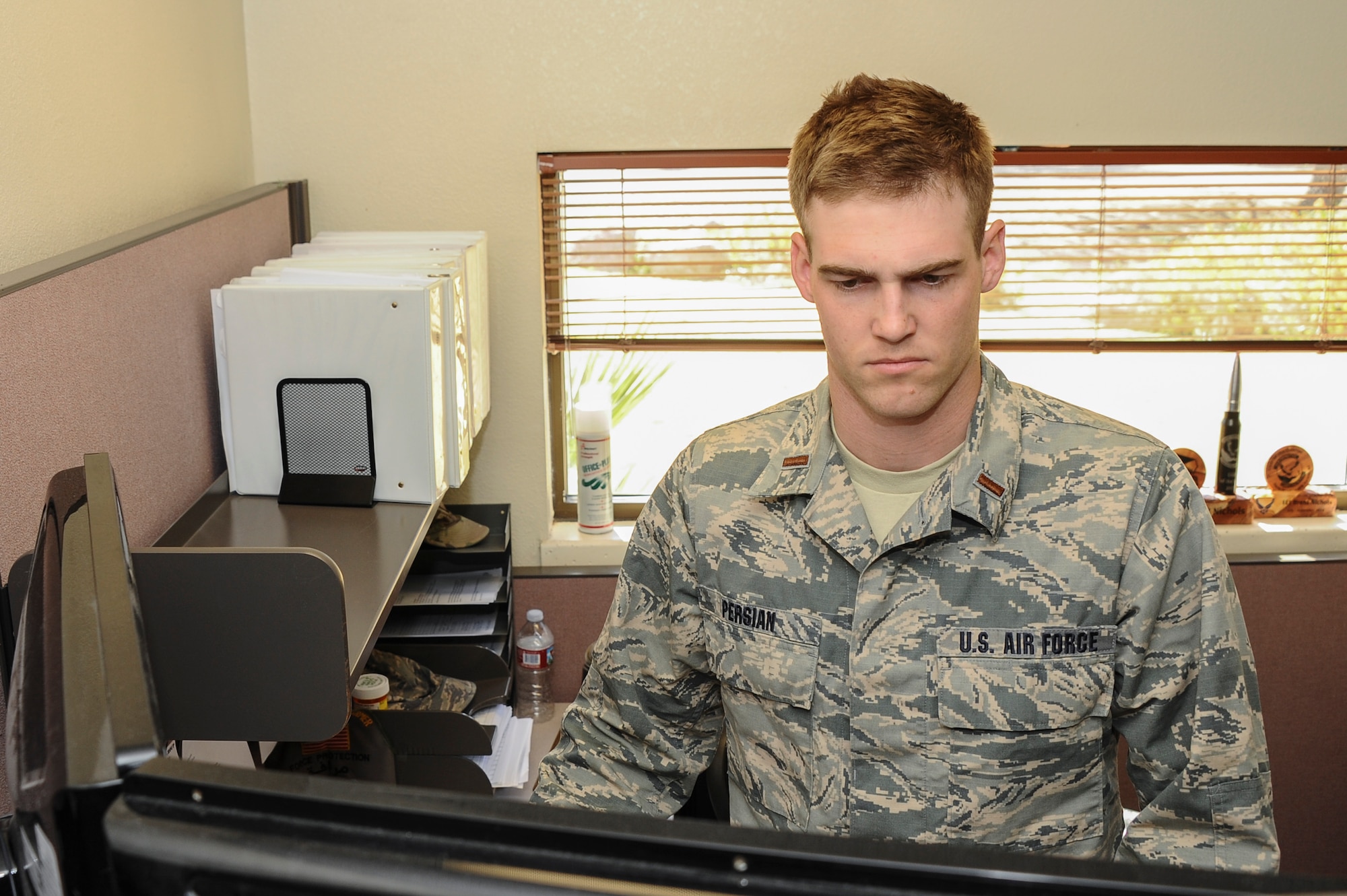 U.S. Air Force 2nd Lt. Benjamin Persian, 355th Contracting Squadron contract administrator, utilizes a standing desk at Davis-Monthan Air Force Base, Ariz., Feb. 17, 2016. Persian presented the idea of standing desks during the first ever Innovate DLT event. The standing desks were presented as a solution to reduce stress, possible injuries and disorders associated with overused muscles, bad posture and repeated tasks for people that work at a desk with certain health concerns. (U.S. Air Force photo by Airman 1st Class Mya M. Crosby/Released)