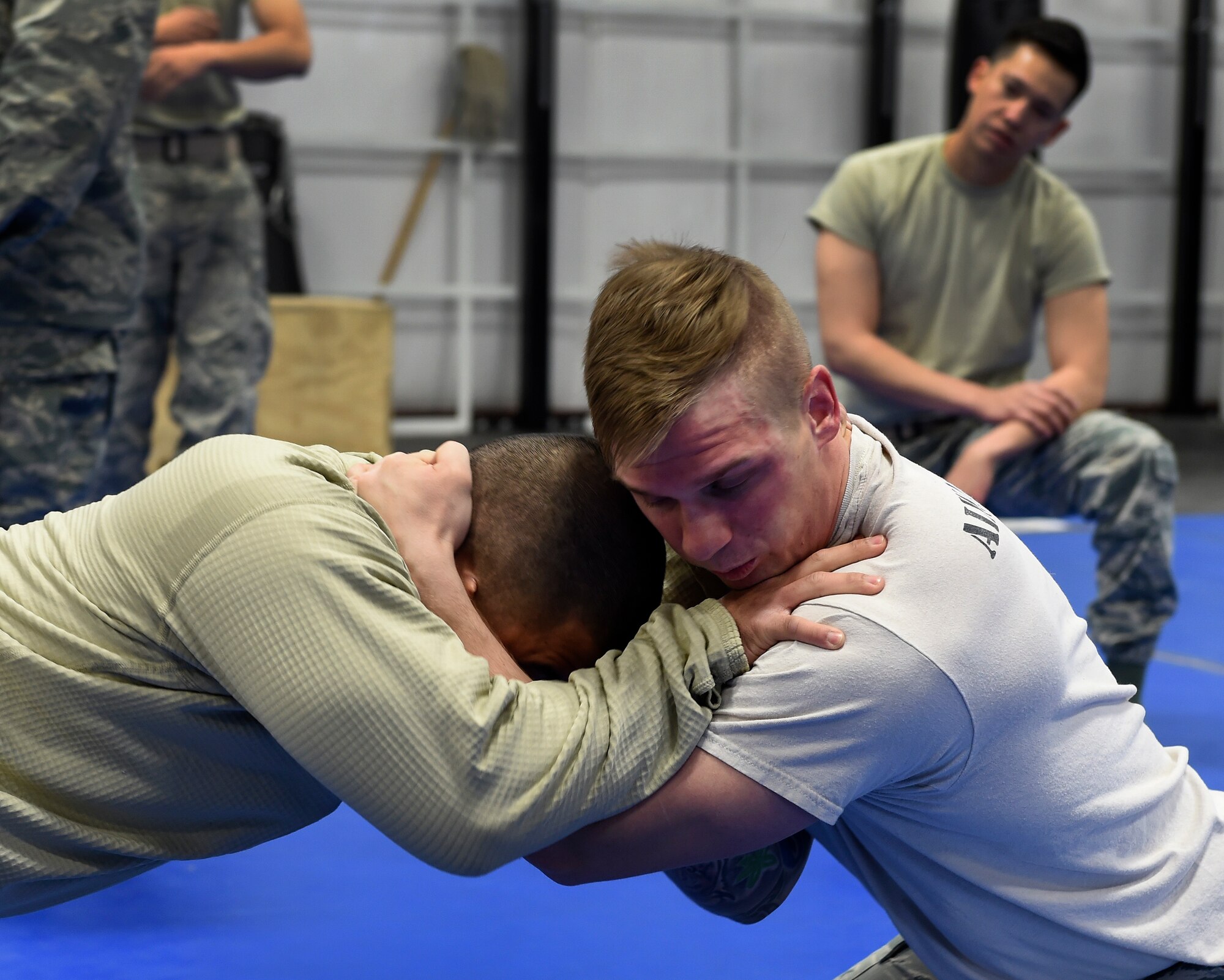 Senior Airman Cameron 799th Security Forces Squadron armory specialist grapples with Senior Airman Blake 799th SFS member Feb. 19, 2016, at Creech Air Force Base, Nevada. SFS Airmen train on defensive moves to help them defend themselves during combat. (U.S. Air Force photo by Senior Airman Adarius Petty/Released)