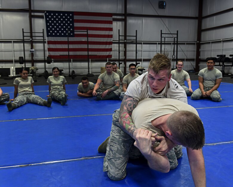 Senior Airman Blake, top, 799th Security Forces Squadron member grapples with Master Sgt. Andrew Jenson 799th SFS first sergeant Feb. 19, 2016, at Creech Air Force Base, Nevada. Combatives training helps SFS physically and mentally prepare for hostile hands-on situations. (U.S. Air Force photo by Senior Airman Adarius Petty/Released)