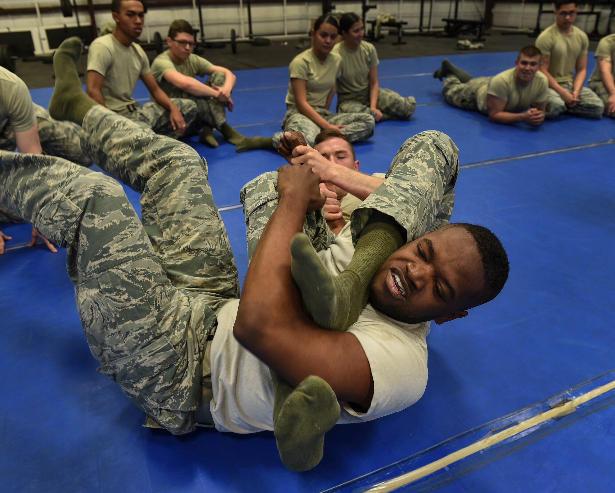 Airman 1st Class Darius 799th Security Forces Squadron member is detained in an arm-bar during a combatives class, Feb. 19, 2016, at Creech Air Force Base, Nevada. SFS members demonstrated extensive skills that will help them defend themselves during combat. (U.S. Air Force photo by Senior Airman Adarius Petty/Released)