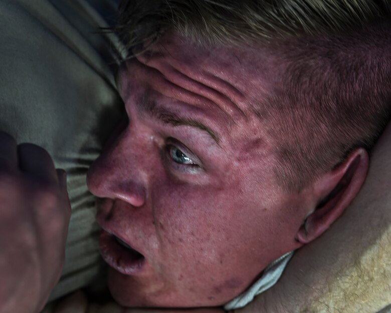 Master Sgt. Andrew 799th Security Forces Squadron first sergeant places Senior Airman Blake 799th SFS member a chokehold during a combatives class Feb. 19, 2016, at Creech Air Force Base, Nevada. Security Forces members train on defensive skills that will help them overcome dangerous situations in combat. (U.S. Air Force photo by Senior Airman Adarius Petty/Released)