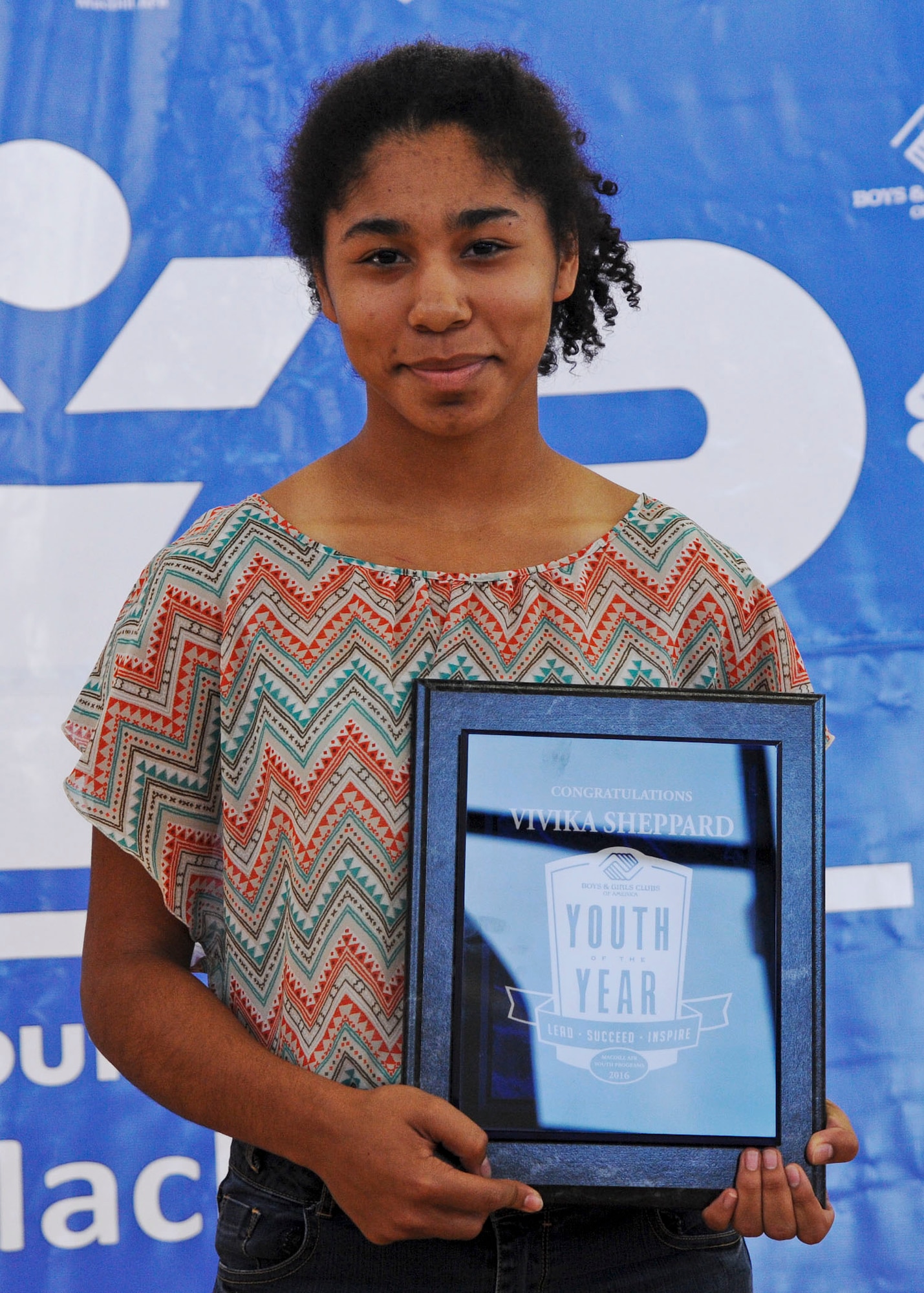 Vivika Sheppard, a 10th grade student attending Robinson High School, displays her Youth of the Year 2016 plaque from the Youth Center at MacDill Air Force Base, Fla., Feb. 16, 2016. Sheppard was chosen as MacDill’s Military Youth of the Year for embodying the values of leadership, service, academic excellence and a healthy lifestyle. (U.S. Air Force photo by Senior Airman Danielle Quilla)
