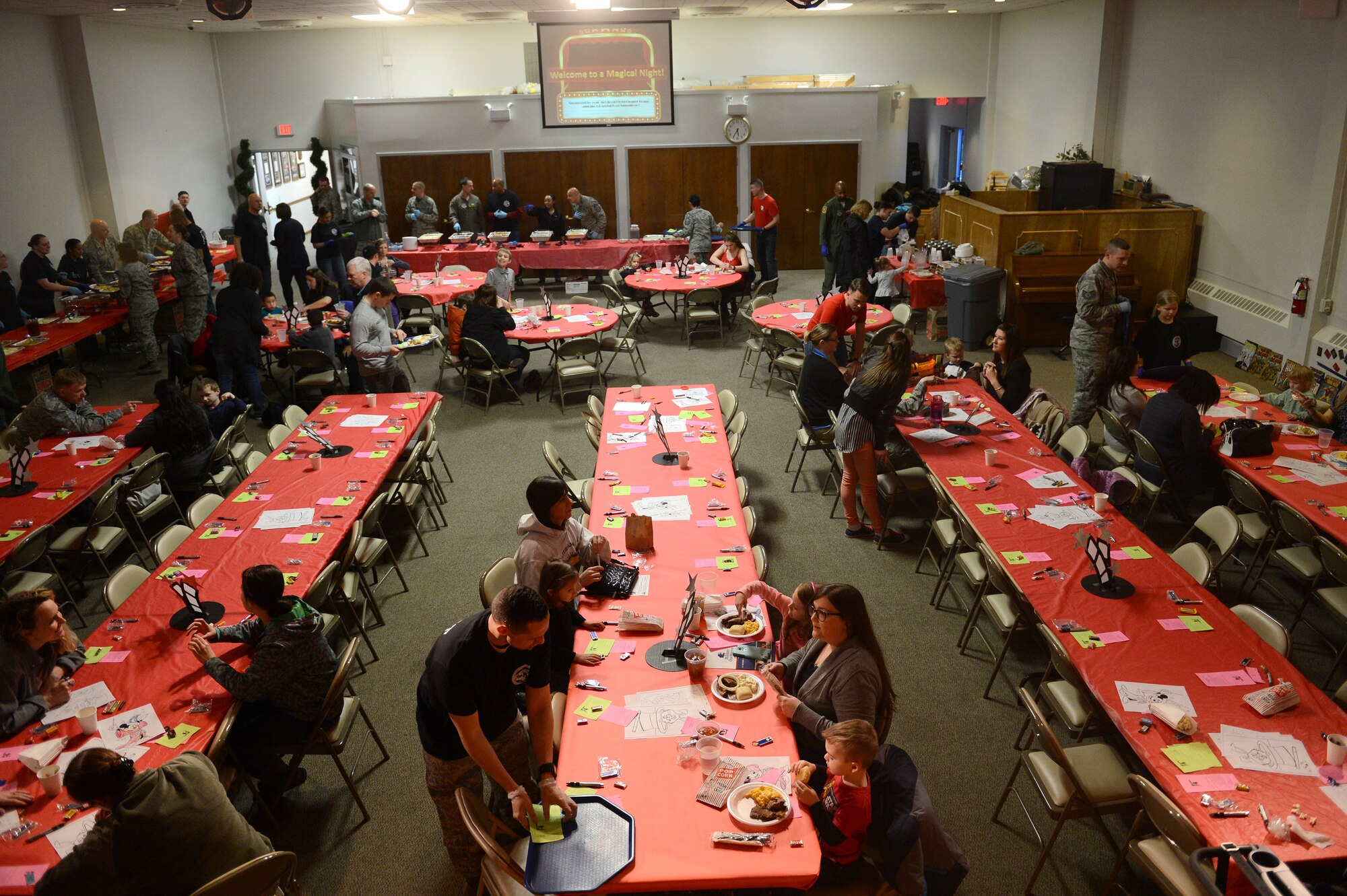 Family members of deployed service members wait to be served during the Team McChord Deployed Family Dinner Feb. 19, 2016 at the Chapel Support Center on Joint Base Lewis-McChord, Wash. The event included dinner for the families and entertainment for the children. (U.S. Air Force photo/Senior Airman Divine Cox)