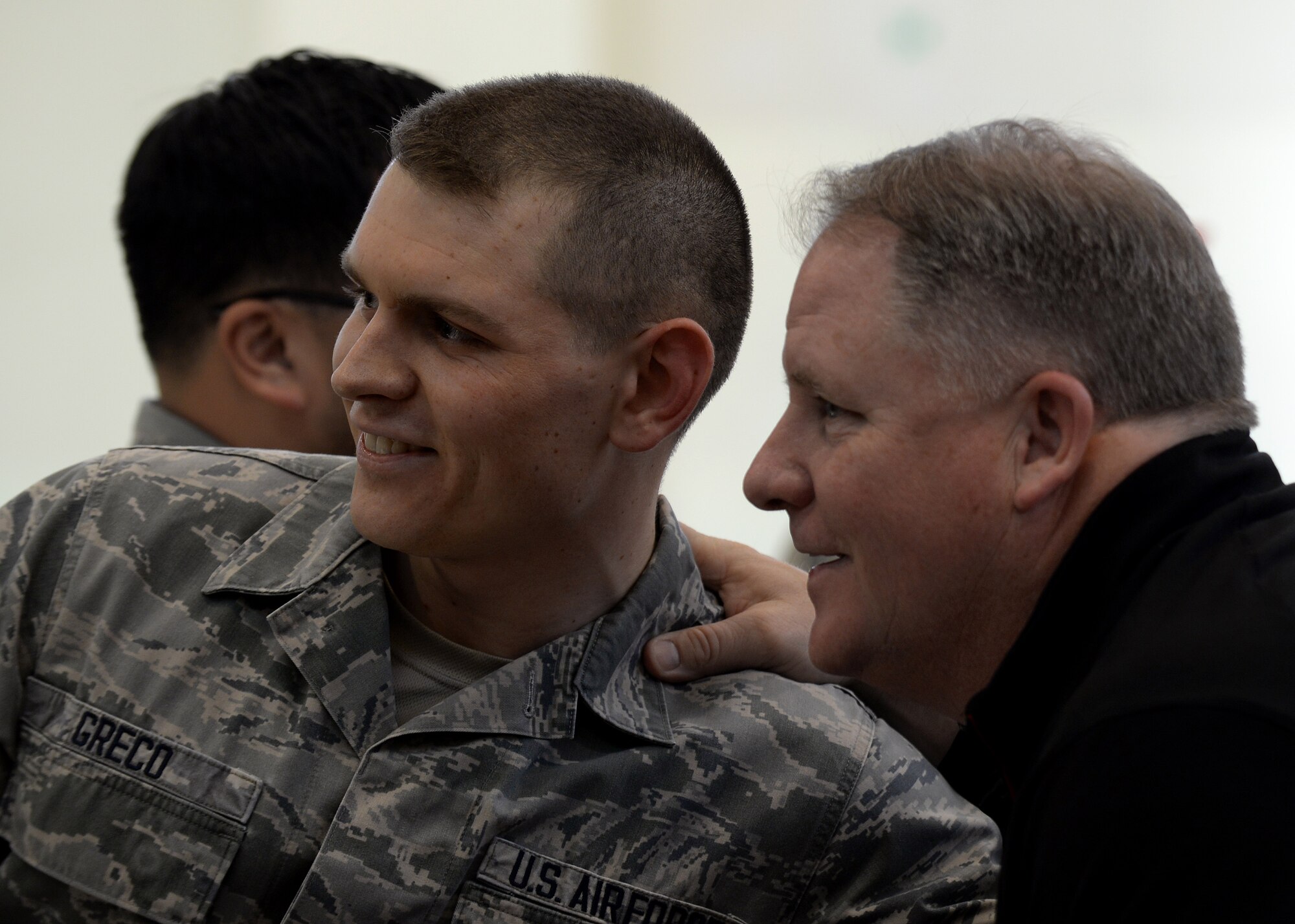 U.S. Air Force Senior Airman Joseph Greco, 31st Logistics Readiness Squadron command support staff supervisor, gets his photo taken with Chip Kelly, San Francisco 49ers head coach, during the 2016 Coaches Tour, Feb. 18, 2016, at Aviano Air Base, Italy. The coaches visited Aviano during their week-long tour that took them throughout Europe and the Middle East. (U.S. Air Force photo by Airman 1st Class Cary Smith/Released)
