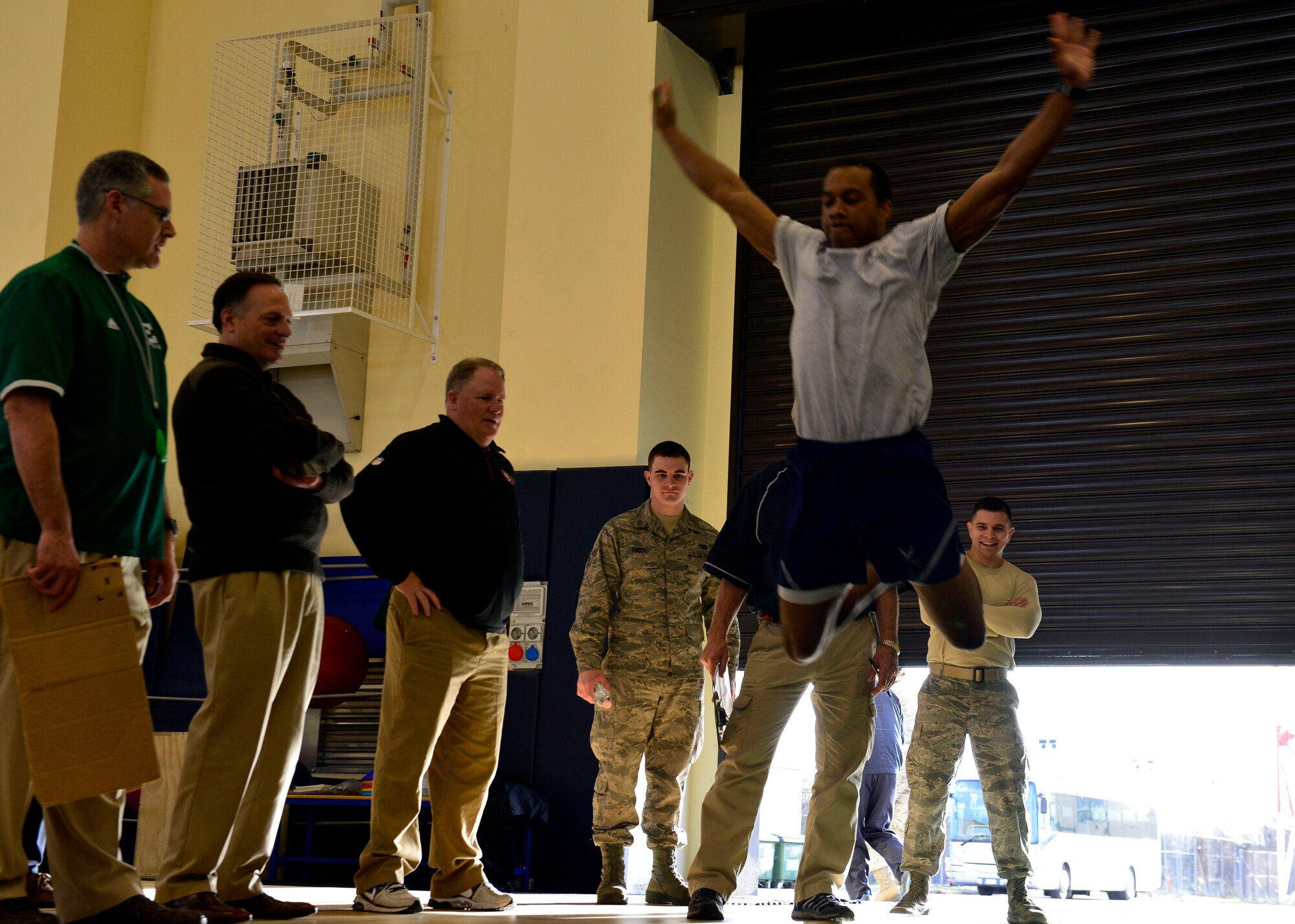 Football coaches manage a mock football combine during the 2016 Coaches Tour, Feb. 18, 2016, at Aviano Air Base, Italy. A Football combine tests an athlete’s size, speed and strength by performing several physical activities. (U.S. Air Force photo by Airman 1st Class Cary Smith/Released)
