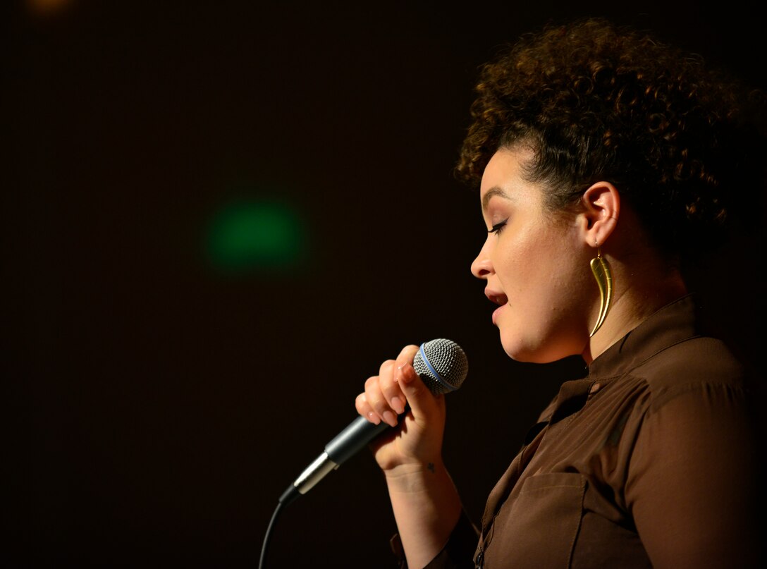 Delira Abraham sings during the Aviano Idol competition, Feb. 18, 2016, at Aviano Air Base, Italy. The Aviano Idol winner will be announced and presented a grand prize of $1000 at the end of the fifth round of judging, March 17, 2016. (U.S. Air Force photo by Airman 1st Class Cory W. Bush/Released))