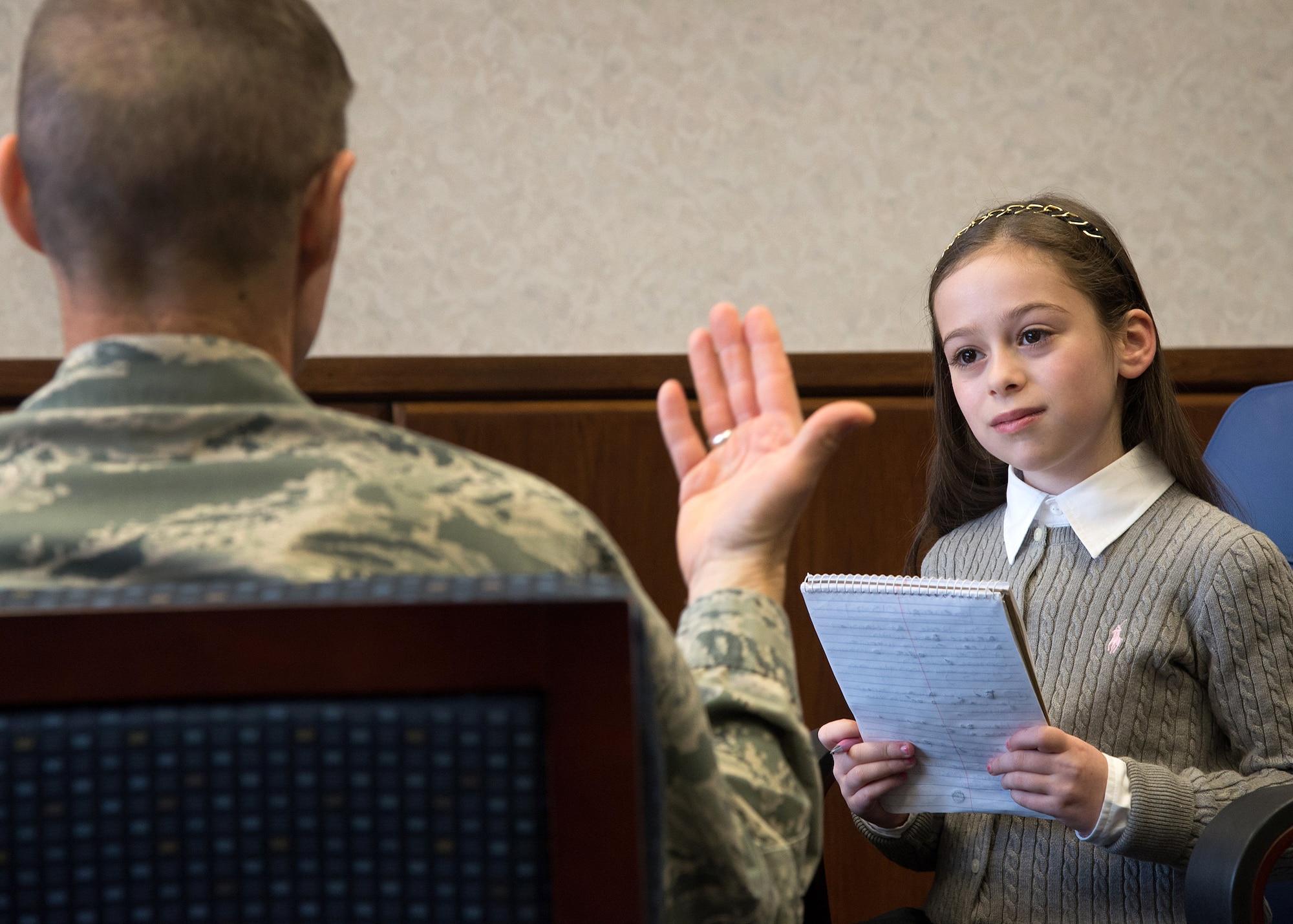 Shayna Rose, 9, interviews Maj. Gen. Craig Olson, C3I and Networks Directorate program executive officer, during a visit to Hanscom Air Force Base, Mass., Feb. 11. Rose, a local third-grader, publishes a weekly newspaper titled The Rose Reporter. (U.S. Air Force photo by Mark Herlihy) 