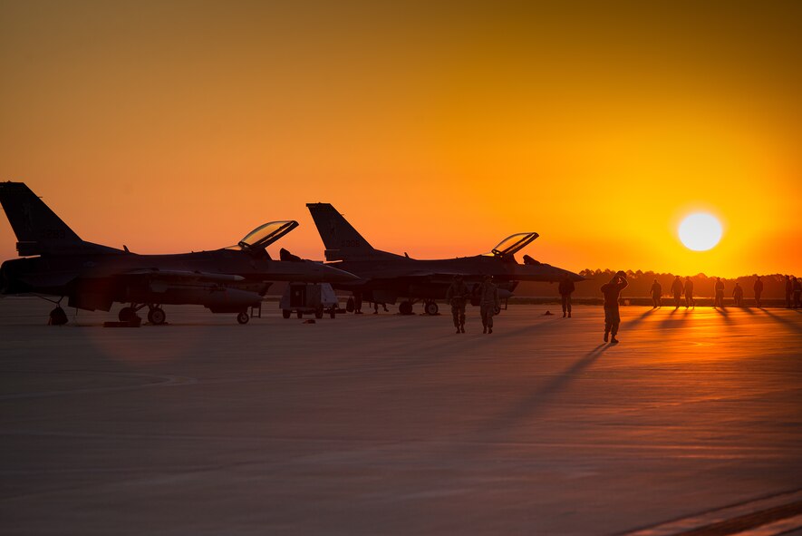 Airmen with the 158th Fighter Wing Maintenance Squadron conduct an early morning foreign object debris walk before daily operations on the flight line at Eglin Air Force Base, Fla., Feb. 8, 2016. The Green Mountain Boys participated in operation Combat Hammer, a Weapon System Evaluation Program. The WSEP evaluates the effectiveness of precision guided munitions when employed in air-to-ground combat. (U.S. Air Force photo by Airman 1st Class Jeffrey Tatro)