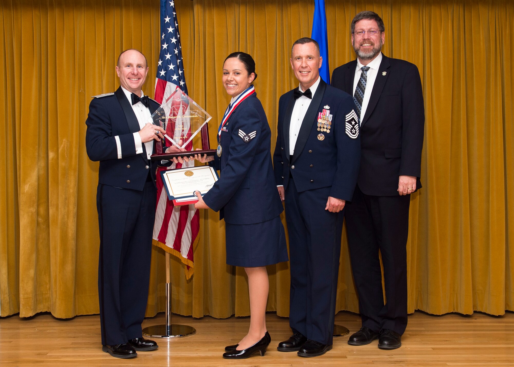 From left to right: Brig. Gen. Carl Schaefer, 412th Test Wing commander, presents the 2015 Airman of the Year award to Senior Airman Raquel R. Caramanno, 412th Medical Group, along with Chief Master Sgt. David Smith, 412th TW command chief, and Danny Bazzelle. (U.S. Air Force photo by Ethan Wagner)