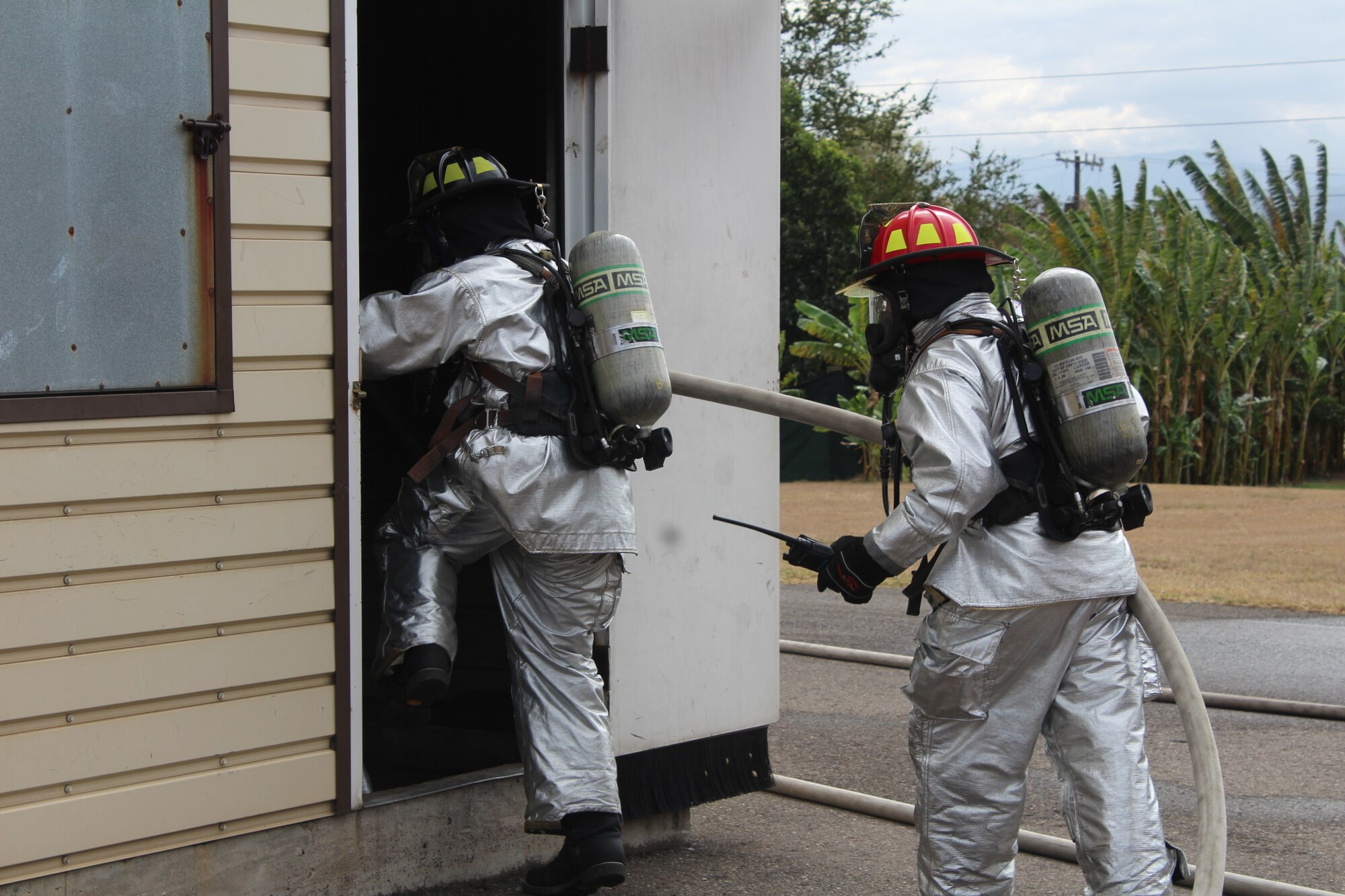 SOTO CANO AIR BASE, Honduras – Firefighters with the 612th Air Base Squadron Fire Department, enter the Soto Cano “burn house” during a simulated structural fire, Feb. 18, 2016, at Soto Cano Air Base, Honduras. The firefighters participate in monthly familiarization and proficiency exercises that help maintain their ability to respond to different emergency situations. (U.S. Army photo by Maria Pinel) 