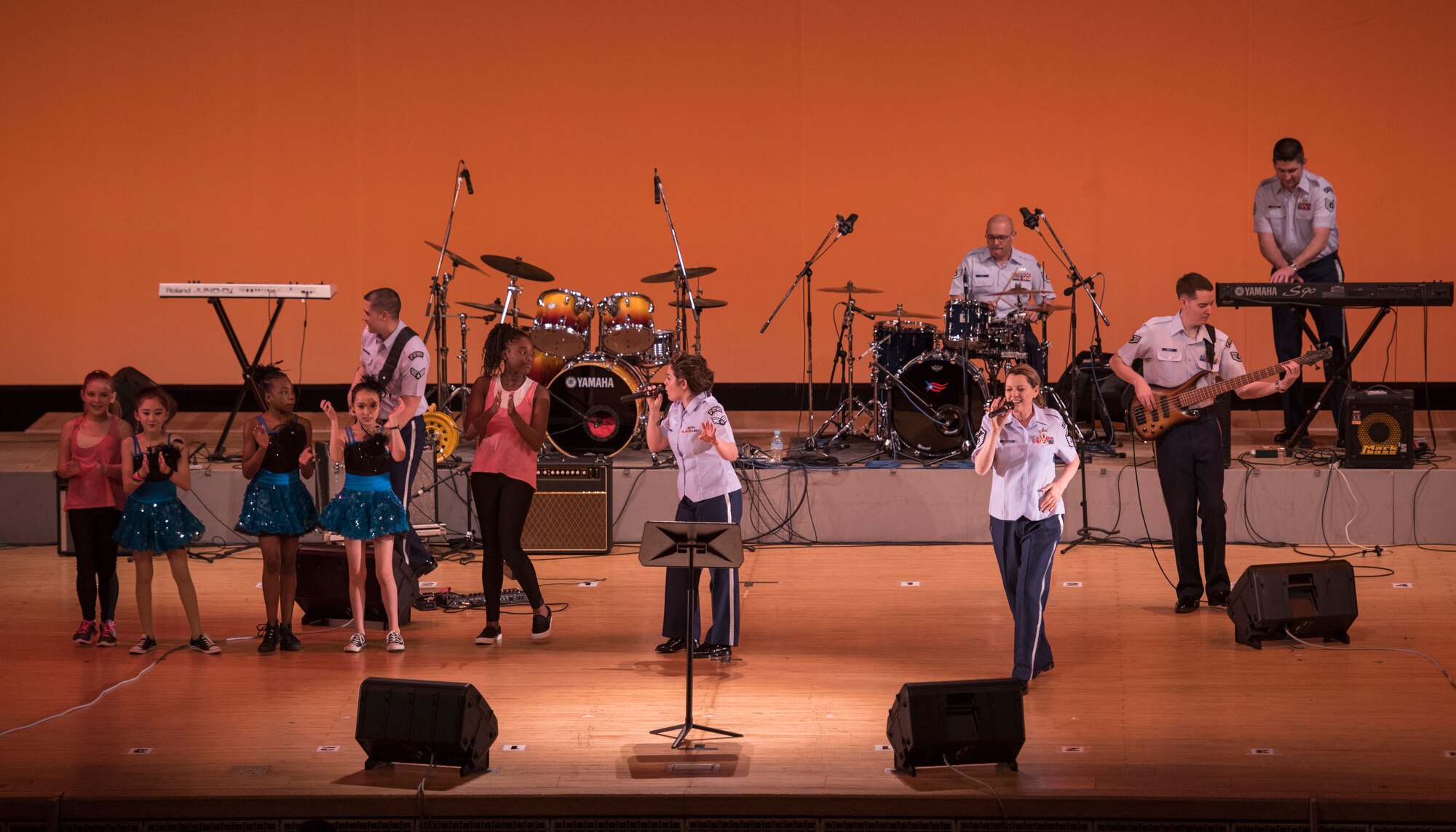 Members of the Air Force Band of the Pacific-Asia, Pacific Trends, perform onstage with members of the Yokota Dance Company during the Japan-U.S. Joint Concert at Kotori Hall in Akishima, Tokyo, Japan, Feb. 20, 2016. The North Kanto Defense Bureau hosted the event to help foster better relationships between Japanese and U.S. members. (U.S. Air Force photo by Staff Sgt. Michael Washburn/Released)