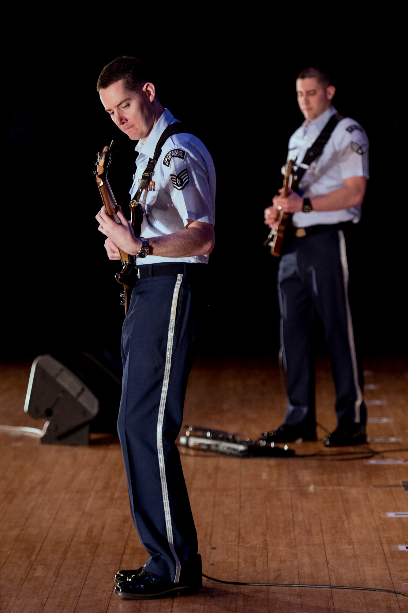 Staff Sgt. Gregory Pflugh, Air Force Band of the Pacific-Asia, plays his guitar during the Japan-U.S. Joint Concert at Kotori Hall in Akishima, Tokyo, Japan, Feb. 20, 2016. The Air Force Band of the Pacific-Asia, also known as Pacific Trends, closed out the event with a final song that included all of the other performers. (U.S. Air Force photo by Staff Sgt. Michael Washburn/Released)