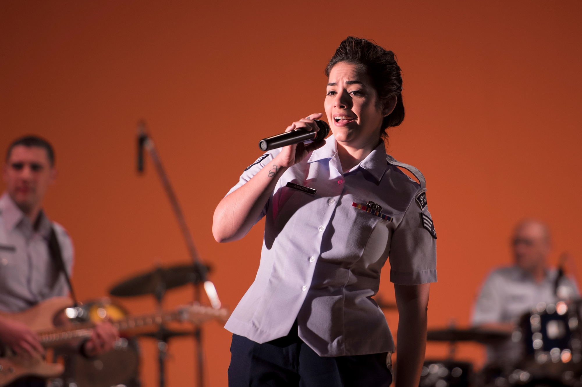 Senior Airman Maritzaida Amador, Air Force Band of the Pacific-Asia, sings during the Japan-U.S. Joint Concert at Kotori Hall in Akishima, Tokyo, Japan, Feb. 20, 2016. The North Kanto Defense Bureau hosted the event to help foster better relationships between Japanese and U.S. members. (U.S. Air Force photo by Staff Sgt. Michael Washburn/Released)