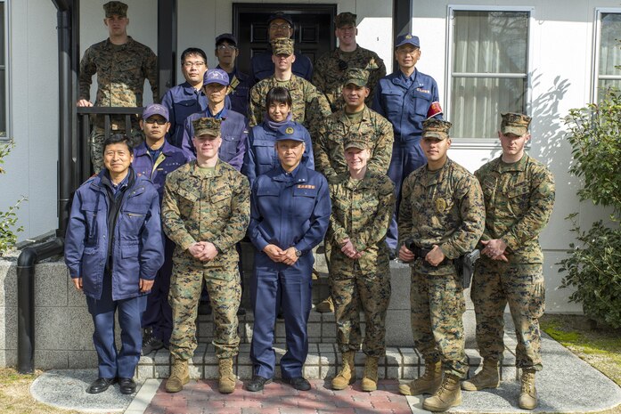 Officers from the Hiroshima Prefectural Police Headquarters and Marines from the provost marshal’s office K-9 unit pose for a photo at Marine Corps Air Station Iwakuni, Japan, Feb. 17, 2016. The Marines provided the officers with training that allows them and their K-9’s to locate hidden explosives by familiarizing them with scented boxes. Conducting bilateral training helps maintain situational readiness and build better relations between the U.S. and Japan.