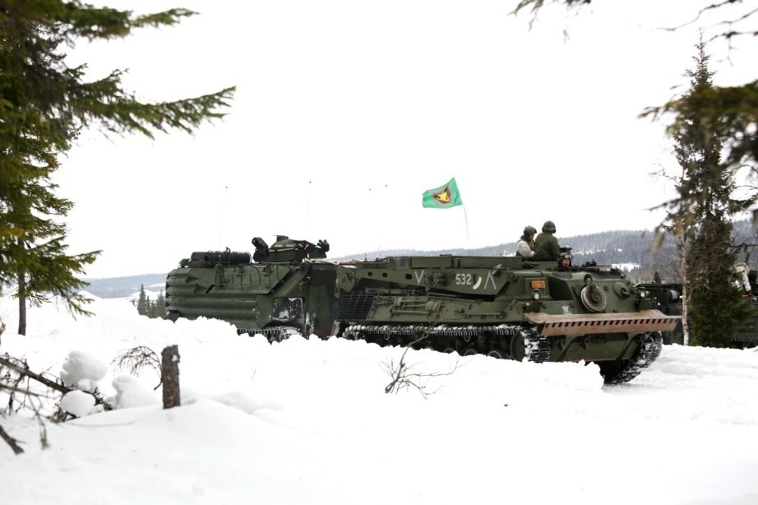 A Norwegian recovery vehicle hooks up to a U.S. Marine Corps Amphibious Assault Vehicle prior to the start of a live-fire range in Rena, Norway, as part of their pre-exercise training Feb. 17,2016. The Marines and Norwegian Army are working together as part of Exercise Cold Response, a joint NATO and allied country exercise comprised of 12 countries and approximately 16,000 troops. The U.S. European Command appreciates the opportunity for taking part in such a large multinational exercise at the invitation of our Norwegian Allies; and we are especially thankful for the chance to put our skills to the test in unique cold weather conditions. (U.S. Marine Corps photo by Master Sgt. Chad McMeen/Released)